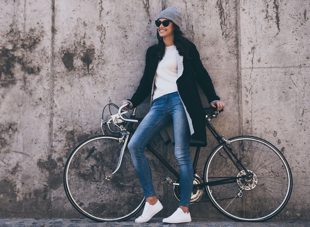 women in jeans on bike